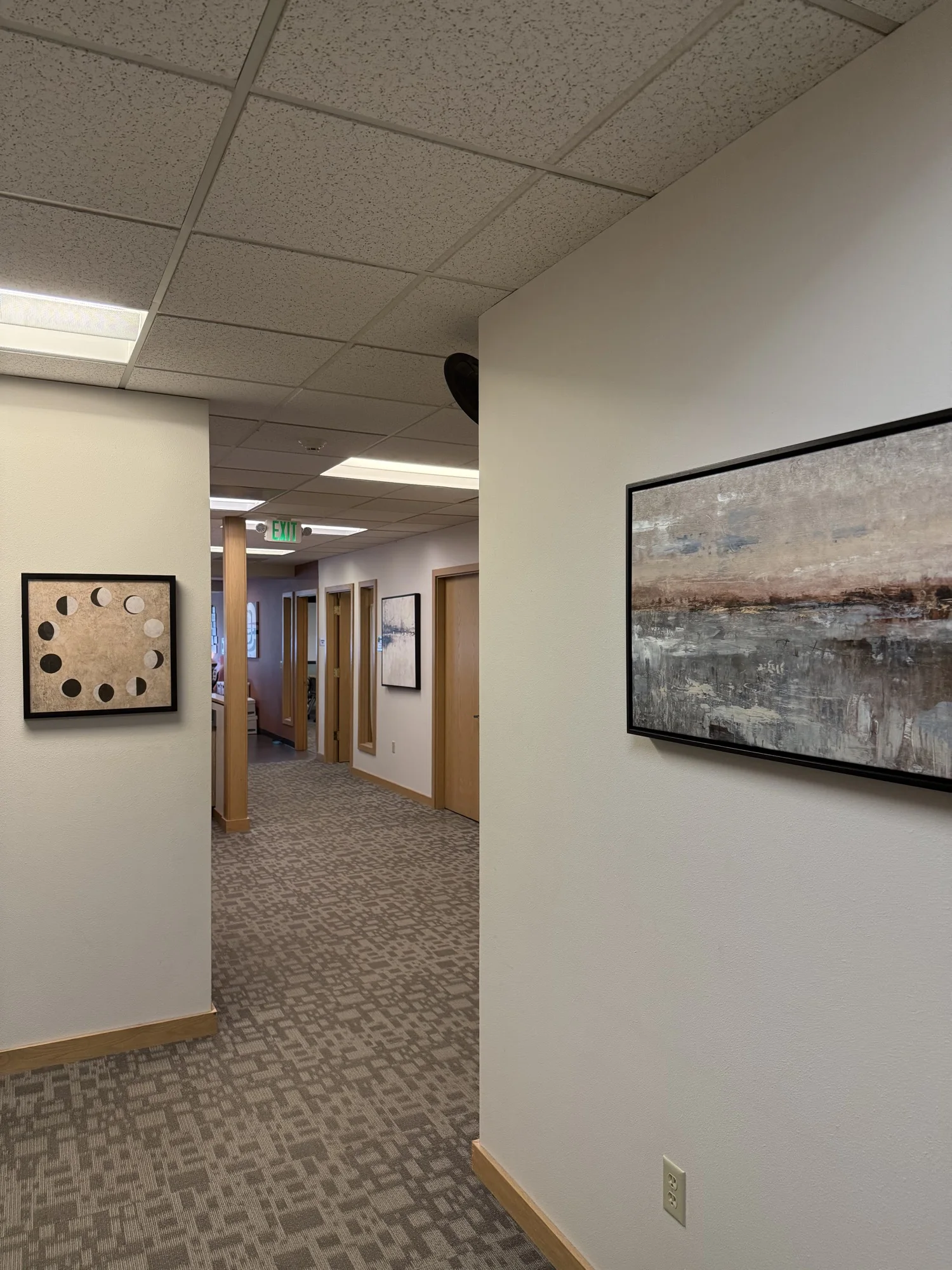 Interior corridor with framed artwork and perimeter offices