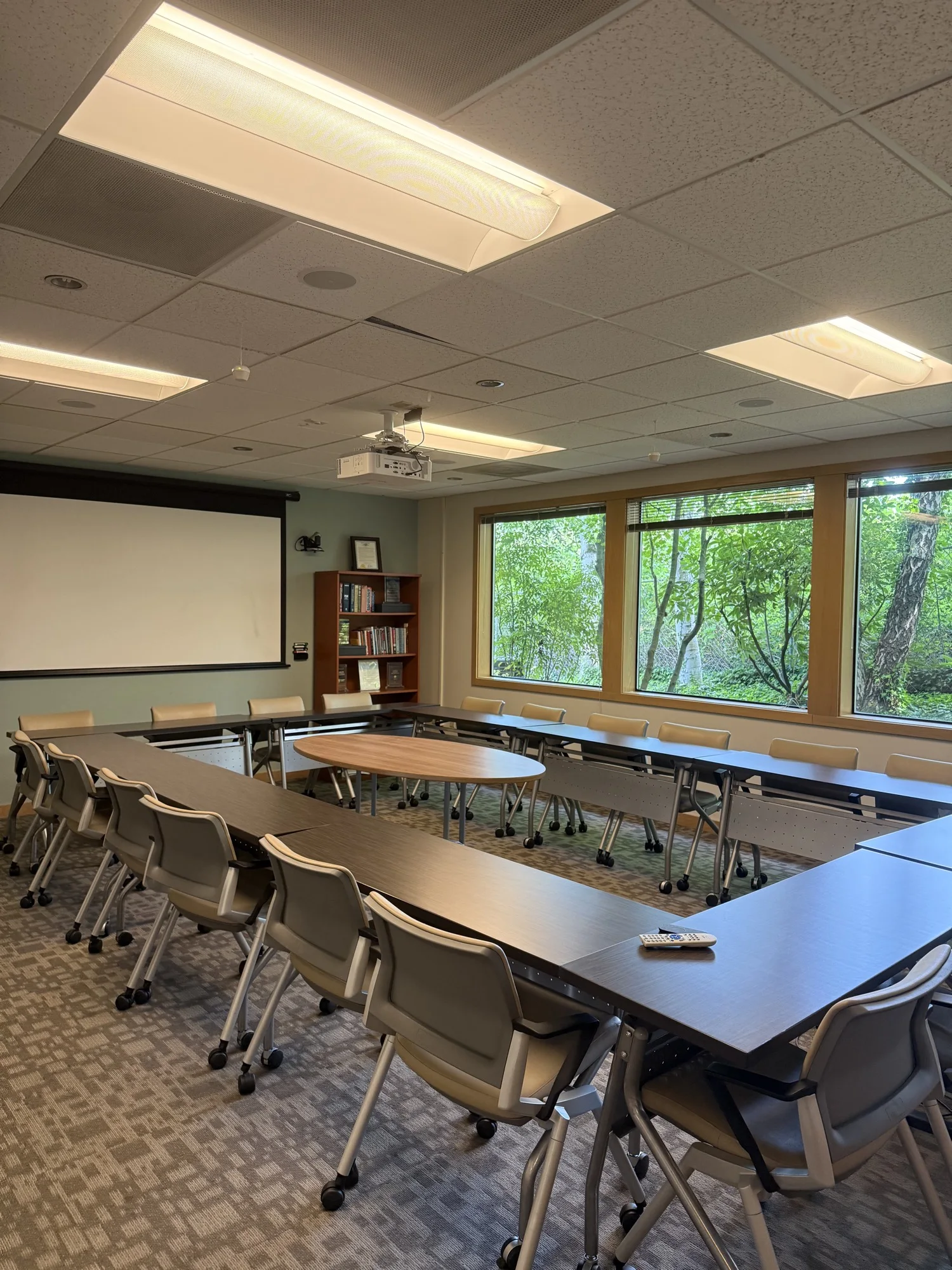 Large conference and training room with windows overlooking mature landscaping